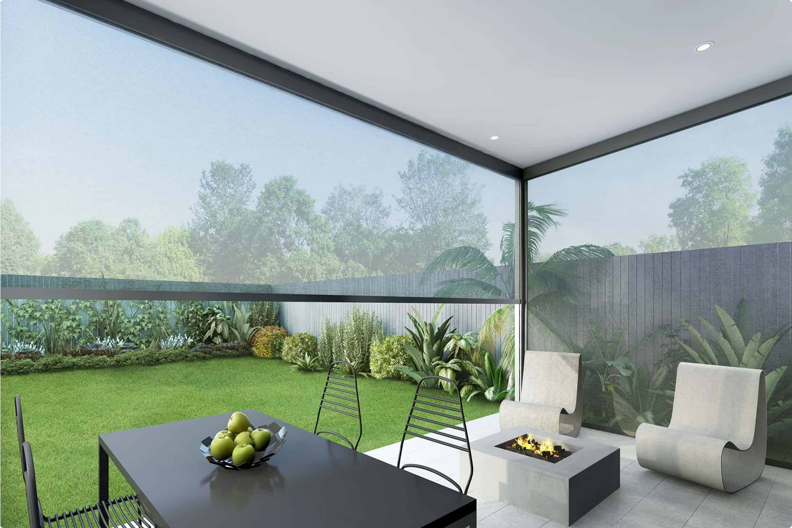 Modern patio with two chairs by a fire pit, dining table with fruit bowl, and view of a landscaped backyard through a transparent screen.