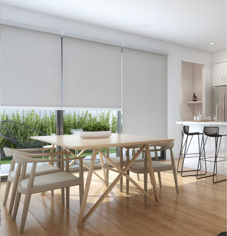 roller (1) Modern kitchen and dining area with light wood furniture, barstools, and large windows covered by white roller blinds; patio greenery visible outside.