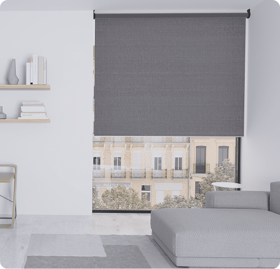 A modern living room with a grey roller shade partly covering a large window, minimalistic furniture, and floating shelves on a white wall.