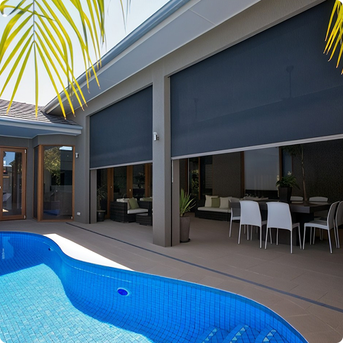 Modern patio with a small blue-tiled pool, outdoor dining table with white chairs, and large retractable shades covering glass doors and windows.